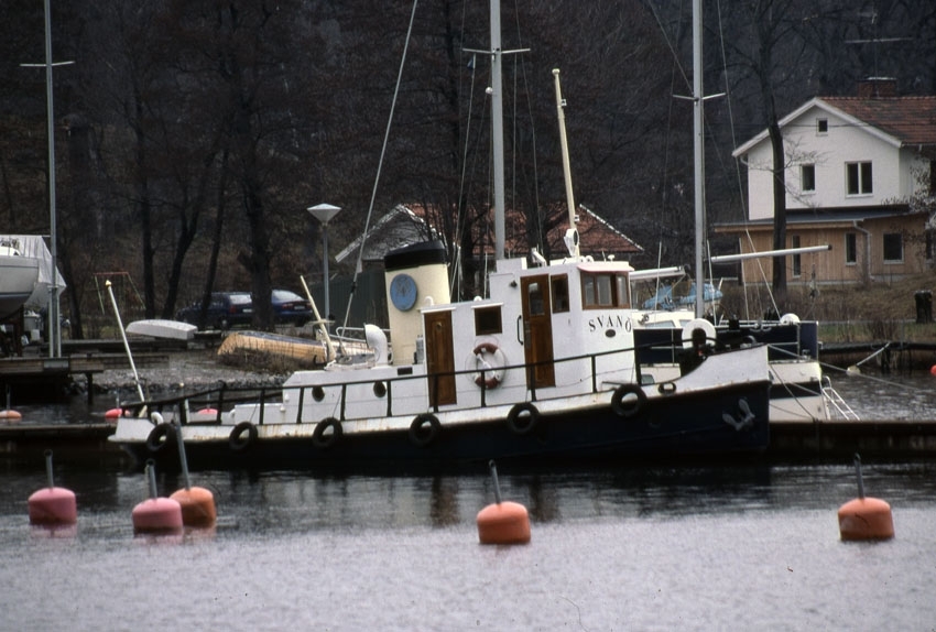 Svanö är en mindre bogserbåt med svart skrov och vit överbyggnad. Fartyget har en gul skorsten bakom styrhytten. På bilden ligger båten vid en brygga. 